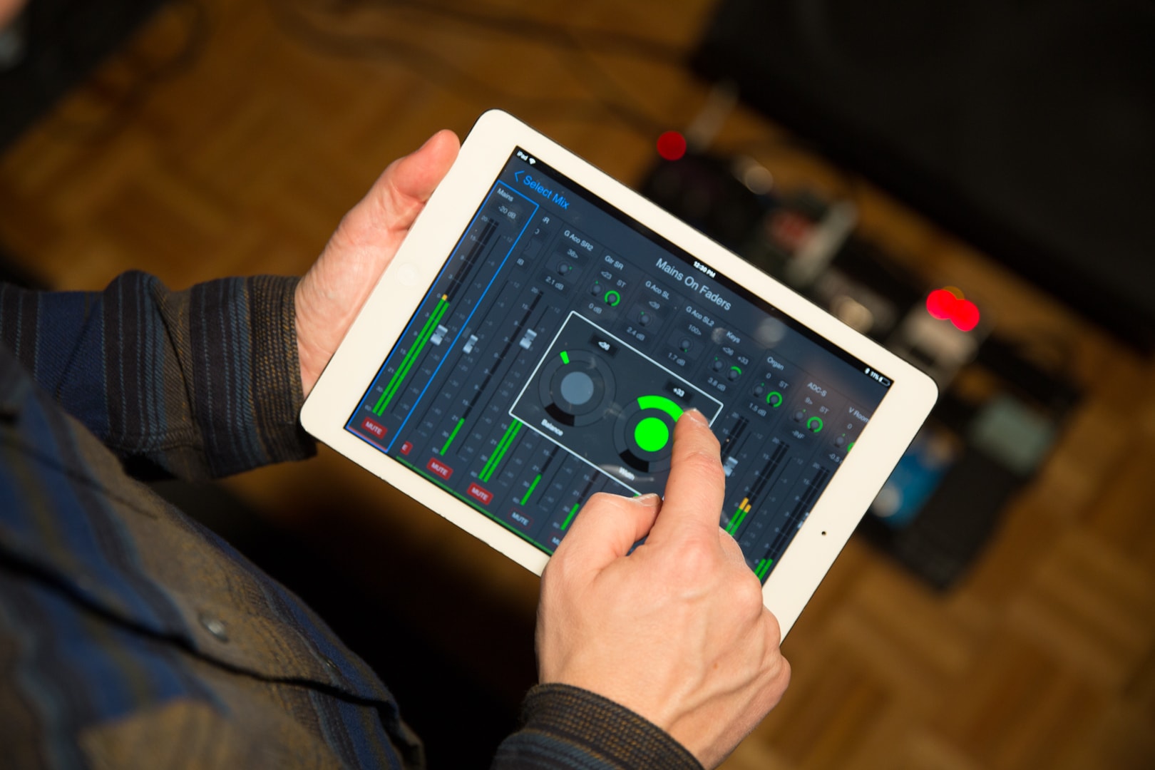 Musician using VENUE Onstage in ear monitor app to control mixes